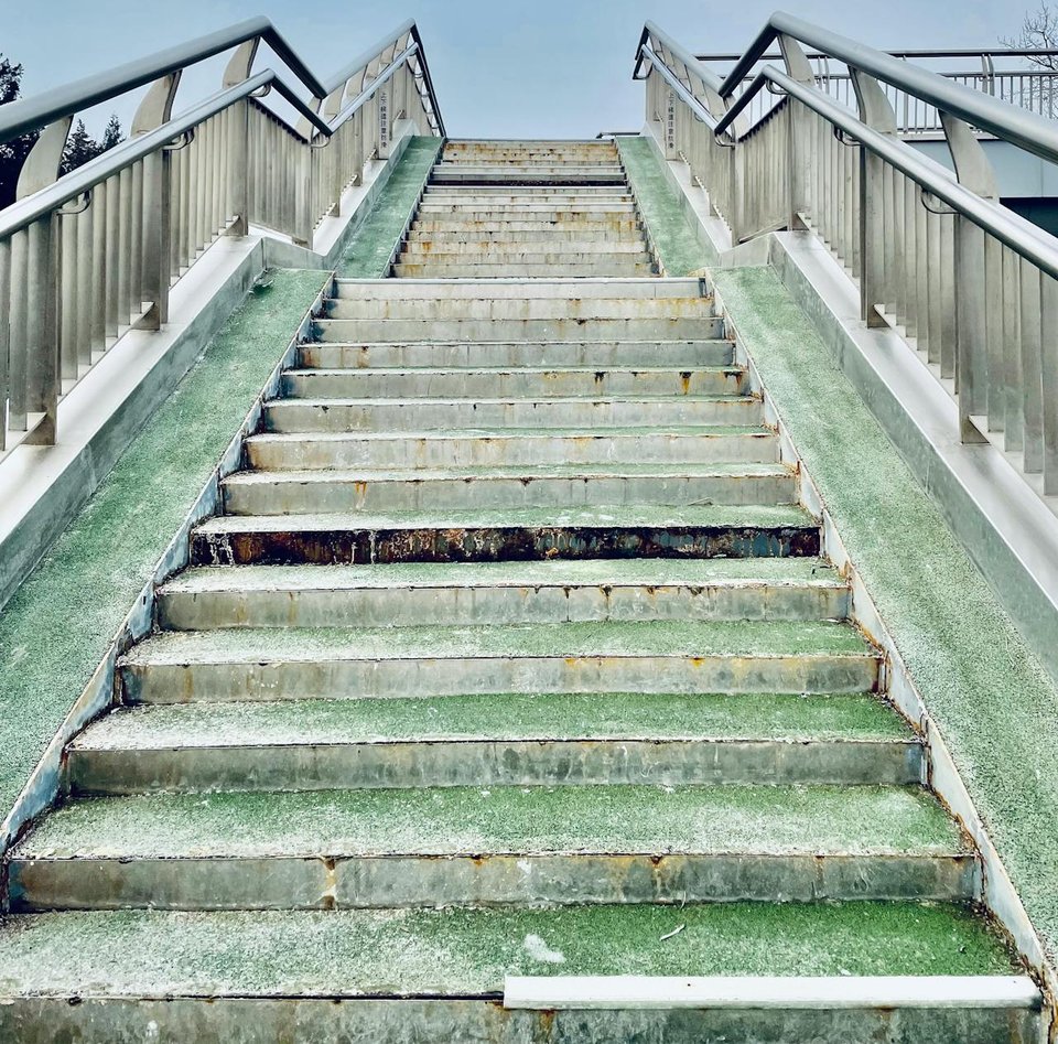 A low angle shot of stairs with handrails, photo by Shuaizhi Tian
